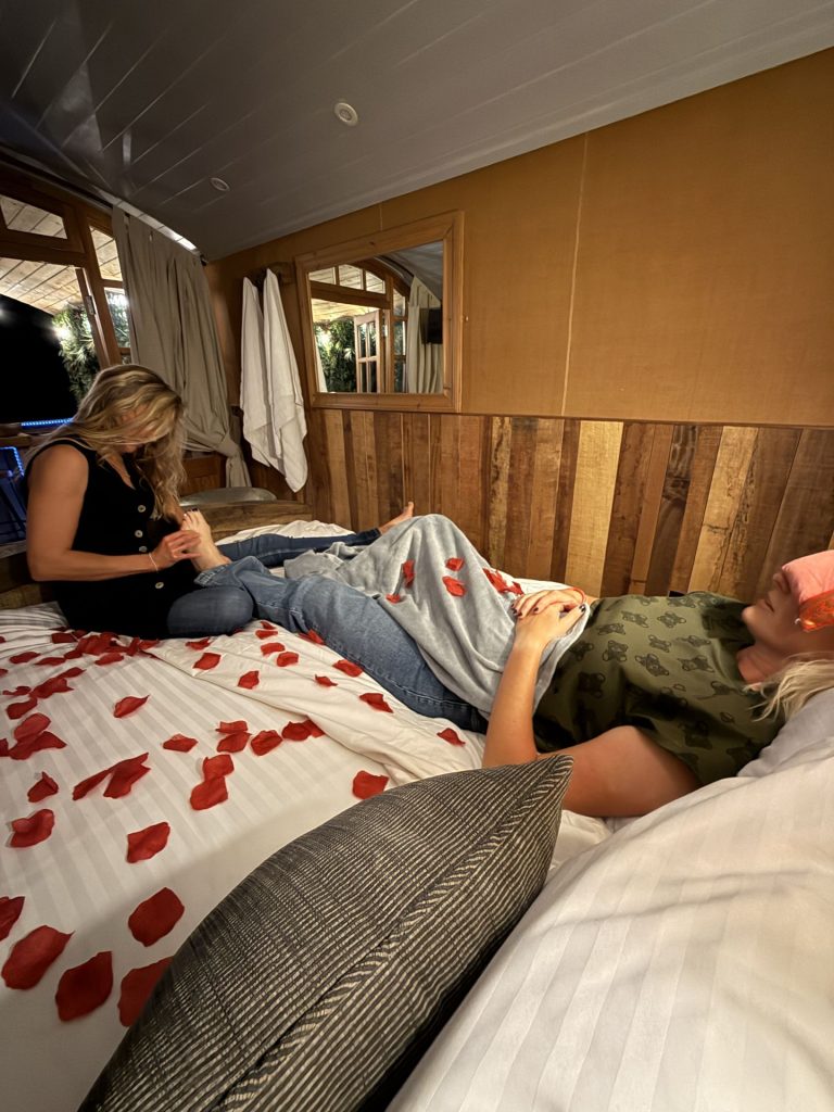 Reflexology foot treatment on the bed of a shepherd's hut, Ockeridge Rural Retreats, Worcestershire